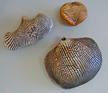 Hanging vessel, stoneware, impressed potter's seal, 15cm across, another sculptural fossil style vessel, impressed potter's sea